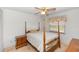 Cozy bedroom featuring a four-poster bed, a nightstand, a window, and a ceiling fan for comfortable living at 2621 Ardon Ave, Orlando, FL 32833