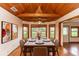 Charming dining room with wood ceiling, lots of natural light, and a marble table at 2621 Ardon Ave, Orlando, FL 32833