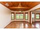 Bright dining room with wood-paneled ceiling and a large bay window overlooking the lawn at 2621 Ardon Ave, Orlando, FL 32833