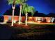 Inviting single-story brick home featuring well-lit exterior and palm trees at 2621 Ardon Ave, Orlando, FL 32833