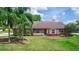 Charming single-story home featuring a lush green lawn and mature palm trees at 2621 Ardon Ave, Orlando, FL 32833