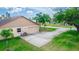Aerial shot of an attached garage with an extended driveway, a well-manicured lawn, and sparse landscaping at 2621 Ardon Ave, Orlando, FL 32833