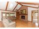 Comfortable living room with exposed beams, a brick fireplace, and skylight to bring in natural light at 2621 Ardon Ave, Orlando, FL 32833