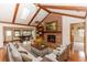 Inviting living room with brick fireplace, vaulted ceiling, and beautiful hardwood floors at 2621 Ardon Ave, Orlando, FL 32833