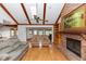 Bright living room with brick fireplace, a vaulted ceiling and a view to the kitchen and living room at 2621 Ardon Ave, Orlando, FL 32833