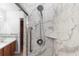 Modern shower with marble-like tile and a safety grab bar at 2621 Ardon Ave, Orlando, FL 32833