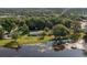 Aerial view of home on the lake showcasing the lush landscaping and waterfront living at 3 Poinsettia Dr, Debary, FL 32713