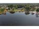 Scenic aerial view showcasing the property's expansive lake frontage, lush greenery, and serene setting at 3 Poinsettia Dr, Debary, FL 32713