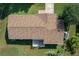 Aerial view of a well maintained roof, backyard deck, and a beautifully landscaped yard with mature trees at 3 Poinsettia Dr, Debary, FL 32713