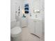 Bright bathroom featuring a toilet, vanity, mirror, and cabinet with blue towels for a fresh, clean space at 3 Poinsettia Dr, Debary, FL 32713