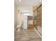 Bathroom with tiled shower, drawers, window and wood-look flooring at 3 Poinsettia Dr, Debary, FL 32713