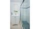 Bathroom with a vanity, window, towel rack, and a glass-enclosed shower showcasing stylish blue mosaic tile accents at 3 Poinsettia Dr, Debary, FL 32713