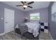 Bedroom features a ceiling fan, wood-look flooring, and windows at 3 Poinsettia Dr, Debary, FL 32713