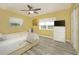 Bedroom features windows, wood-look flooring, and a dresser with television at 3 Poinsettia Dr, Debary, FL 32713
