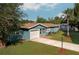 Charming single-story home boasts an attached garage, neat landscaping, and a well-maintained lawn at 3 Poinsettia Dr, Debary, FL 32713