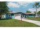 Charming single-story home boasts an attached garage, neat landscaping, and a well-maintained lawn at 3 Poinsettia Dr, Debary, FL 32713