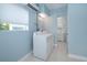 Laundry room features a washer, dryer, window and tiled flooring at 3 Poinsettia Dr, Debary, FL 32713