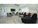 Bright living room featuring stylish decor, a ceiling fan, and large windows for ample natural light at 3 Poinsettia Dr, Debary, FL 32713