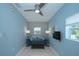 Bright living room with a blue sofa, ottoman and mounted television at 3 Poinsettia Dr, Debary, FL 32713