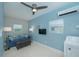 Bright living room features a blue sofa, ottoman and mounted television at 3 Poinsettia Dr, Debary, FL 32713