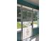 View of a screened porch with decorative wrought iron door that provides an extra layer of security and privacy at 3 Poinsettia Dr, Debary, FL 32713