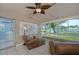 Inviting sunroom with tile flooring, comfortable seating, and a scenic lake view through large windows at 3 Poinsettia Dr, Debary, FL 32713