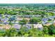 Aerial view of a home in a neighborhood with mature trees and well-maintained lawns at 3033 Zaharias Dr, Orlando, FL 32837