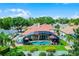 Lush backyard with a screened-in pool, hot tub, and ample green space at 3033 Zaharias Dr, Orlando, FL 32837