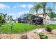 Beautiful backyard with a screened-in pool, lush lawn, and serene landscaping at 3033 Zaharias Dr, Orlando, FL 32837
