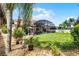 Expansive backyard featuring lush landscaping, screened-in patio, and a tranquil pool area at 3033 Zaharias Dr, Orlando, FL 32837