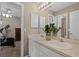 Double sink bathroom featuring a walk-in shower, medicine cabinets, and exercise equipment just outside the door at 3033 Zaharias Dr, Orlando, FL 32837