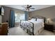 Comfortable bedroom with plush carpet, a ceiling fan, and natural light from the large window at 3033 Zaharias Dr, Orlando, FL 32837