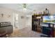 Spacious bedroom featuring a ceiling fan, media center, and entryways to a bathroom and hallway at 3033 Zaharias Dr, Orlando, FL 32837