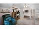 Upstairs bonus room featuring carpeting, ceiling fan, and mounted decorative shelving with furniture at 3033 Zaharias Dr, Orlando, FL 32837