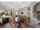 Spacious dining room with a tray ceiling, large wooden table, and staircase access at 3033 Zaharias Dr, Orlando, FL 32837