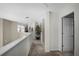 Hallway featuring neutral colored walls, carpeting, and a decorative plant near a white staircase at 3033 Zaharias Dr, Orlando, FL 32837