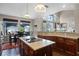 Open concept kitchen with granite countertops, a center island cooktop and breakfast nook with backyard views at 3033 Zaharias Dr, Orlando, FL 32837