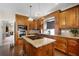 Gourmet kitchen with custom cabinets, granite counters, a center island cooktop, and stainless steel appliances at 3033 Zaharias Dr, Orlando, FL 32837