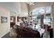 Bright living room with high ceilings, large windows, and a view of the kitchen and outdoor pool area at 3033 Zaharias Dr, Orlando, FL 32837