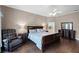 Comfortable main bedroom with neutral walls, a ceiling fan, wood floors, and an ensuite bath at 3033 Zaharias Dr, Orlando, FL 32837