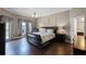 Main bedroom suite features wood floors, a ceiling fan, an ensuite bath, and backyard views at 3033 Zaharias Dr, Orlando, FL 32837