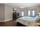 Cozy main bedroom with wood floors, a ceiling fan, and views of the backyard and pool at 3033 Zaharias Dr, Orlando, FL 32837