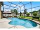 Inviting screened-in pool with a paved deck, gazebo, and well-maintained garden for relaxation and entertainment at 3033 Zaharias Dr, Orlando, FL 32837