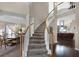 Grand foyer showcases a curved staircase, dining room, and living area with hardwood floors at 3033 Zaharias Dr, Orlando, FL 32837