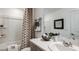 Bright bathroom featuring a shower-tub combination and stylish vanity at 3116 Skyline Loop, Kissimmee, FL 34758
