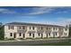 New townhouse property showcasing a contemporary design with a well-maintained lawn and inviting curb appeal at 3166 Skyline Loop, Kissimmee, FL 34758