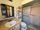 Well-maintained bathroom featuring a shower, sink, and plenty of storage in the shelving unit at 318 Douglas Way # 87, Winter Garden, FL 34787