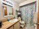 Bathroom with a single sink vanity, medicine cabinet, and a shower/tub combo with a floral shower curtain at 318 Douglas Way # 87, Winter Garden, FL 34787