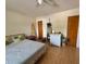 Inviting bedroom with a ceiling fan, unique surfboard decor, and natural light from the window at 318 Douglas Way # 87, Winter Garden, FL 34787