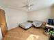 Cozy bedroom featuring a ceiling fan, comfortable chair, and desk, great for unwinding after a long day at 318 Douglas Way # 87, Winter Garden, FL 34787